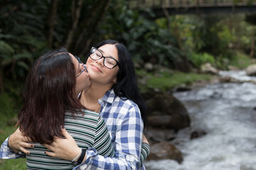 Latina lesbian couple next to a river