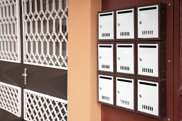 Many metal letter boxes on door outdoors