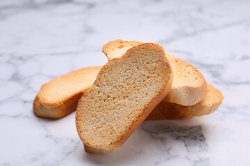 Hard chuck crackers on white marble table, closeup