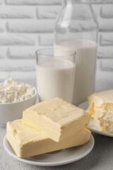 Tasty homemade butter and dairy products on white textured table