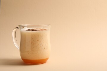 Delicious eggnog with anise on beige background. Space for text