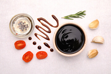 Organic balsamic vinegar and cooking ingredients on white table, flat lay