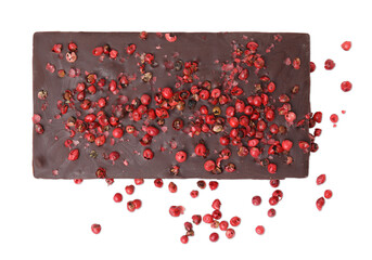 Dark chocolate bar with red peppercorns isolated on white, top view