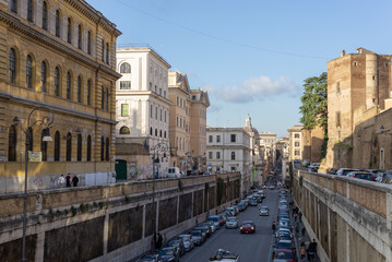 Historic center, via degli Annibaldi with ancient Roman buildings and traffic in Rome, Italy