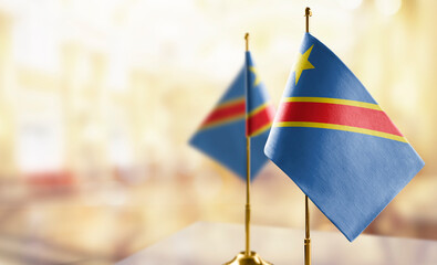 Small flags of the Democratic Republic of the Congo on an abstract blurry background