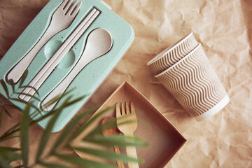 Plastic free, zero waste, disposable tableware and cardboard cups on crumpled paper. Sustainable,...