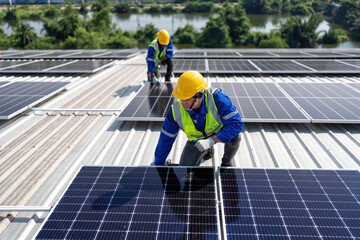 Engineer on rooftop kneeling next to solar panels photo voltaic with tool in hand for installation