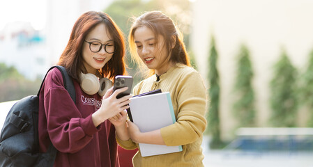 portrait of two beautiful Asian female college students at school