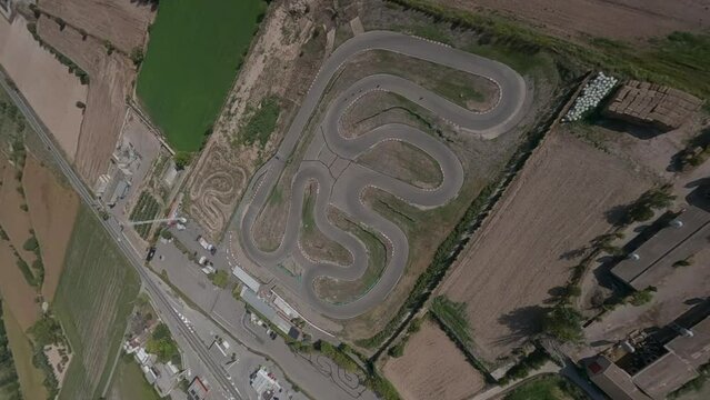 Epic bird's view FPV aerial of Pit Bike track, orbiting on motor sport circuit
