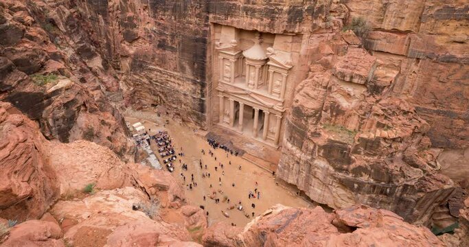 Elevated timelapse view of tourists visiting the Treasury (Al Khazneh) at the ancient city of Petra in Jordan 