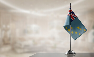 Fototapeta premium A small Tuvalu flag on an abstract blurry background