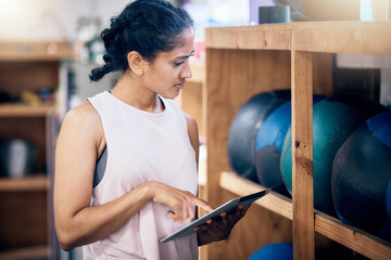 Woman, gym and tablet for equipment inspection, or and balls for training, workout or exercise....