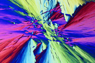 Colorful micro crystals in polarized light. Photo through a microscope - 557101611