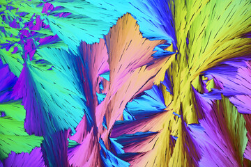 Colorful micro crystals in polarized light. Photo through a microscope