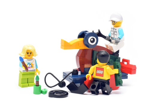 Lego historical toy duck is builded by mini figures from plastic bricks isolated on white. Editorial illustrative image of 90 years of popular brand of children toys.