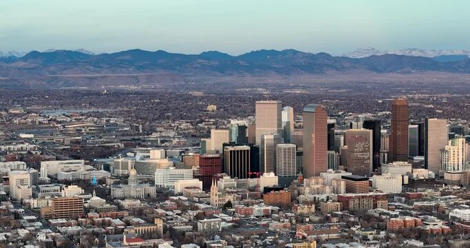 Aerial panorama of downtown Denver. Mountains with snow in the background.