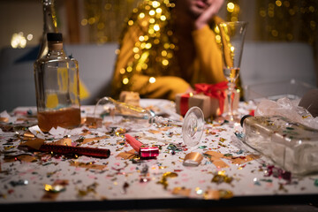 Messy table after party and sitting blurred man in background