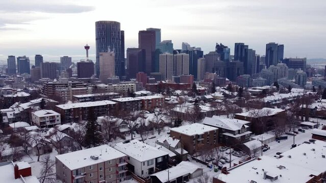 Aerial shot of the Calgary Downtown in winter time and houses covered with snow