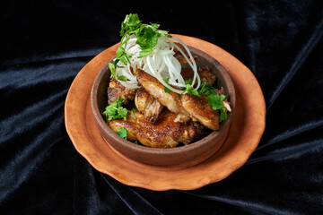 shish kebab with onions in a round plate on black velvet