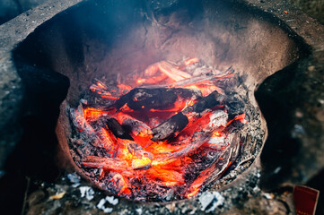 Image of charcoal being burned in an ancient clay oven
