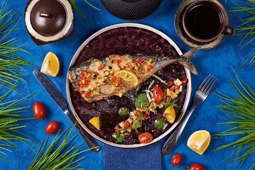 fried fish with vegetables on a blue background