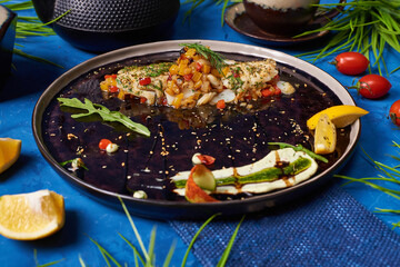 fried walleye with vegetables on a blue background