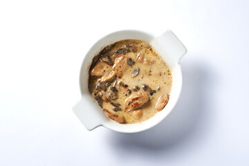 fried mushrooms in sauce on a white background