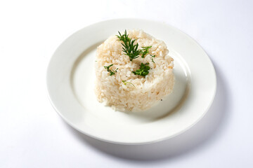 boiled rice with a dill branch on a white background