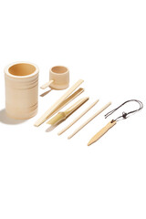 Detailed shot of a tea ceremony tool kit made out of light natural bamboo. The designer tea ceremony set in chinese style is located on the white background.