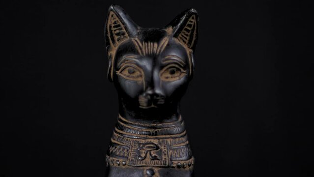 Dolly of a small replica Egyptian Statue of Bastet - Facing Forward - Close Up Right to Left