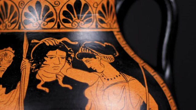 Dolly of a replica Greek Amphora or Vase that tells the myth of Perseus giving the head of Medusa to Athena - Close Up Right to Left
