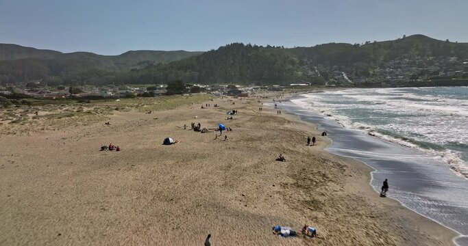 Pacifica California Aerial v3 low level flyover state beach at linda mar capturing beachgoers on the sandy shore with san pedro mountain valley view on a sunny day - Shot with Mavic 3 Cine - May 2022