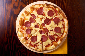 salami pizza on a wooden table