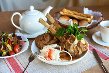 large boiled piece of meat with fresh chopped onion