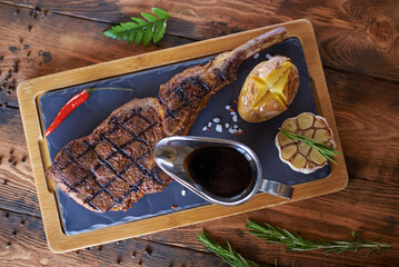 steak with red pepper garlic sauce and baked potatoes