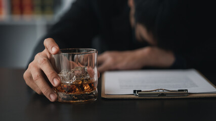 A lawyer holding a glass of whiskey, He's in his office, and he's stressing about arguing for a client, he's a lawyer. The concept of clear legal litigation.