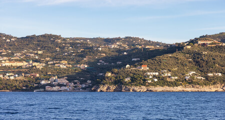 Fototapeta na wymiar Rocky Coast and Homes near Touristic Town, Sorrento, Italy. Amalfi Coast. Sunny Evening