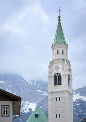 View of the church clock tower in the Dolomites
