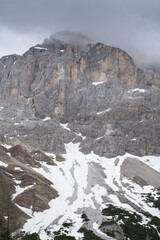 View in the Dolomites of a mountain with some snow at the bottom