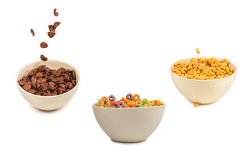 Chocolate corn flakes falling to the white bowl isolated on white. Motion.