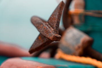 Rusty boat anchor anvil closeup shot with sky background