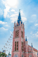 Fototapeta na wymiar Ho Chi Minh City, Vietnam - December 23, 2022: Beautiful morning at Tan Dinh parish church or Church of the Sacred Heart of Jesus is a church located in Ho Chi Minh City. Selective focus