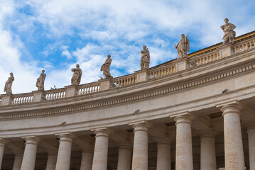 Fototapeta na wymiar Colonnade with statues of saints made of marble in the famous 
