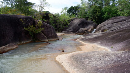 Fototapeta premium Mountain rock formations with flowing river water