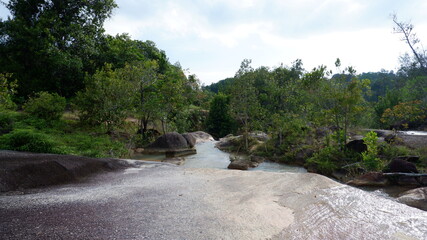 The view from the top of the big rock, flowing river and green forest