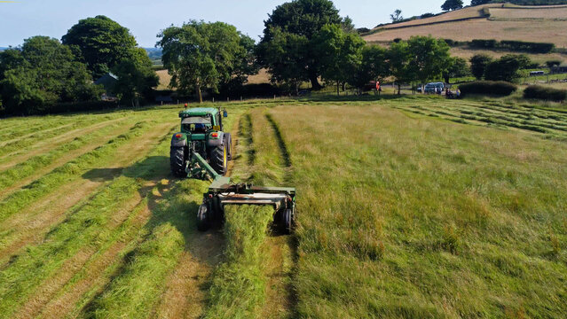 Aerial photo of John Deere 6920 Tractor and Mower cutting Grass for Silage on a Farm in the UK 12-12-22
