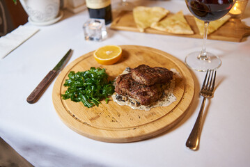 steak with salad and lemon in a restaurant