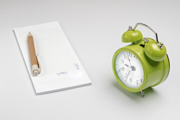 Book and pen with alarm clock. Office hour time concept. Planing koncept