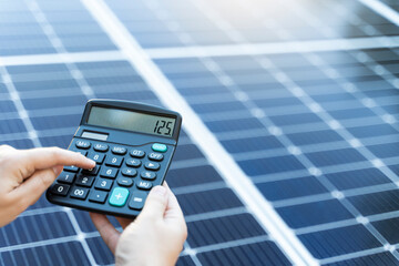 Energy saving concept with solar panels and a calculator
