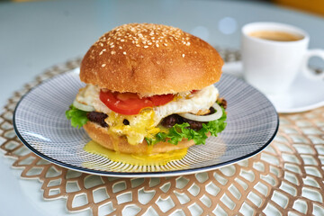 burger in a plate with a cup of coffee